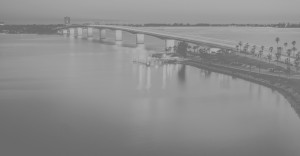 Black and white image of a bridge over water